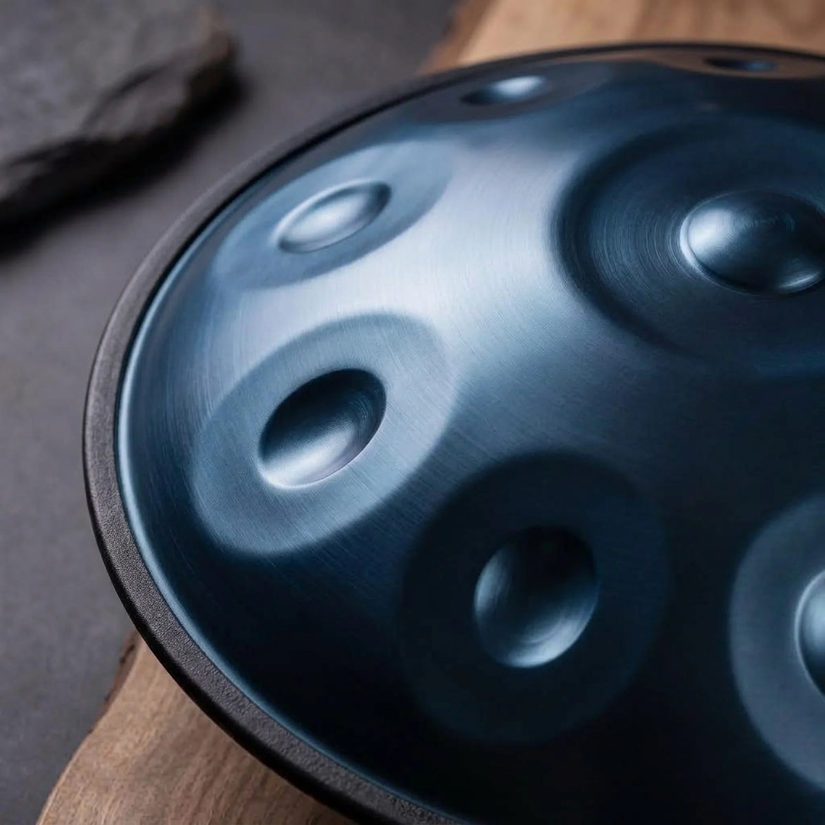 Handpan Equinox D Kurd Kovapan bleu nuit – gros plan champs de notes acier brossé sur bois et ardoise