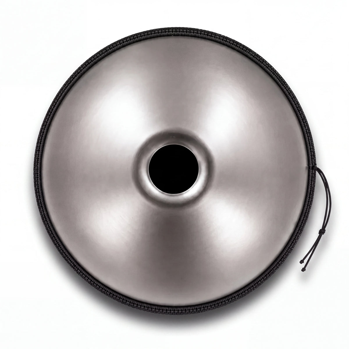 Dessous du mini handpan GRAINE argenté : ouverture centrale (Gu) et bordure noire – Kovapan